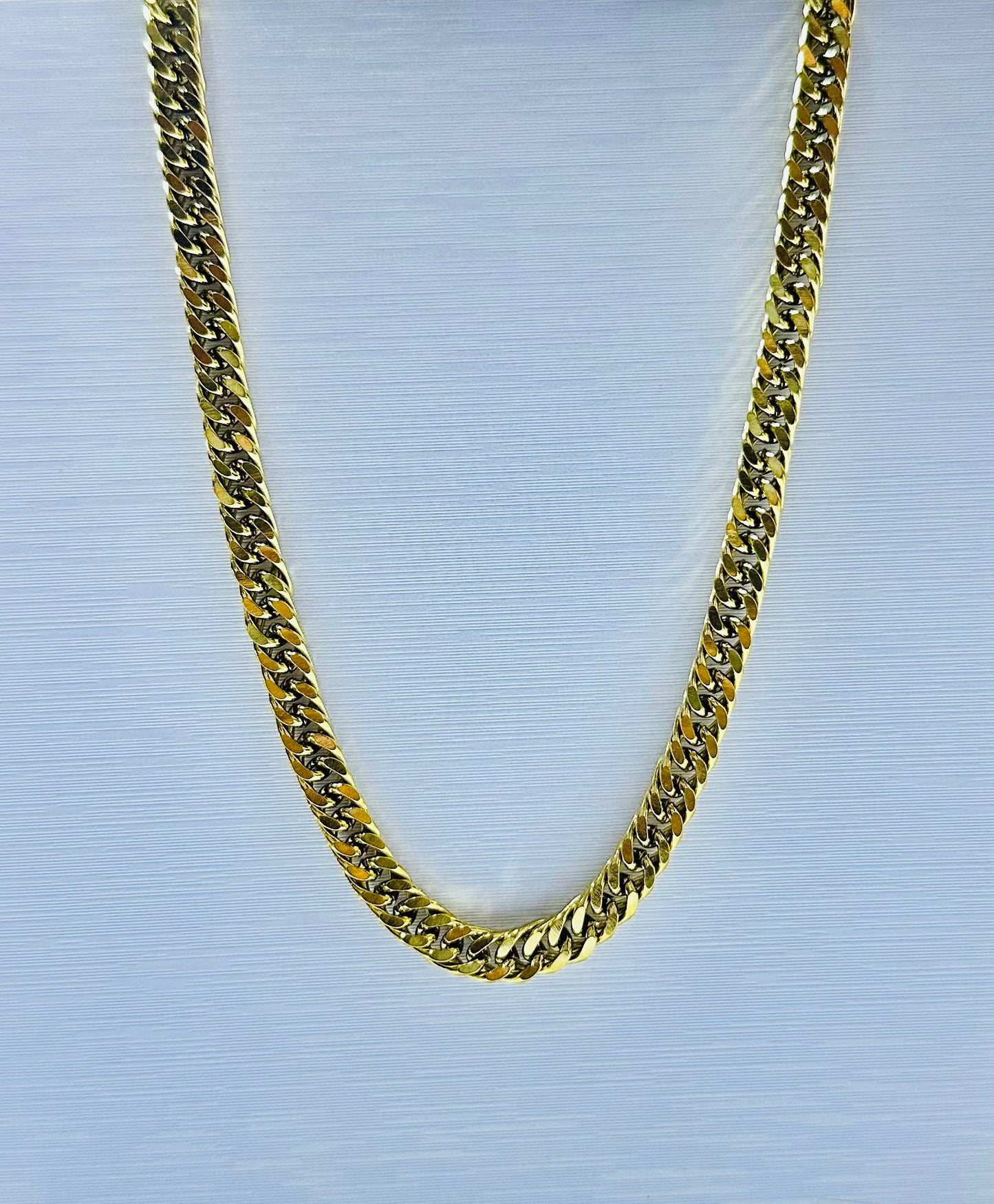 Collar lomo de corvina en acero dorado de varón #5 (60cm)