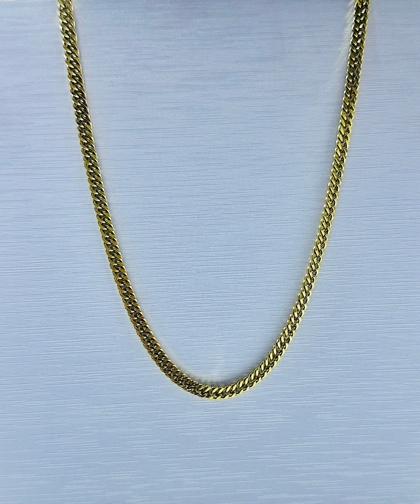 Collar lomo de corvina en acero dorado de varón #2 (60cm)